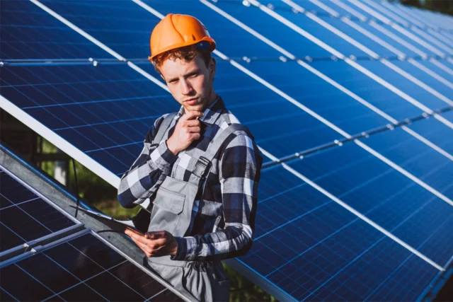 man worker firld by solar panels